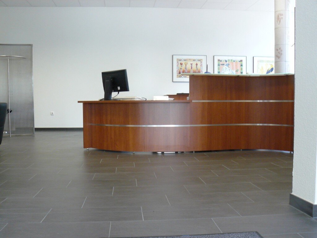 Curved reception desk in warm wood veneer