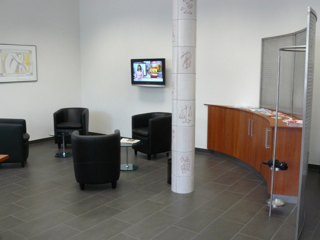 Waiting area with black leather armchairs