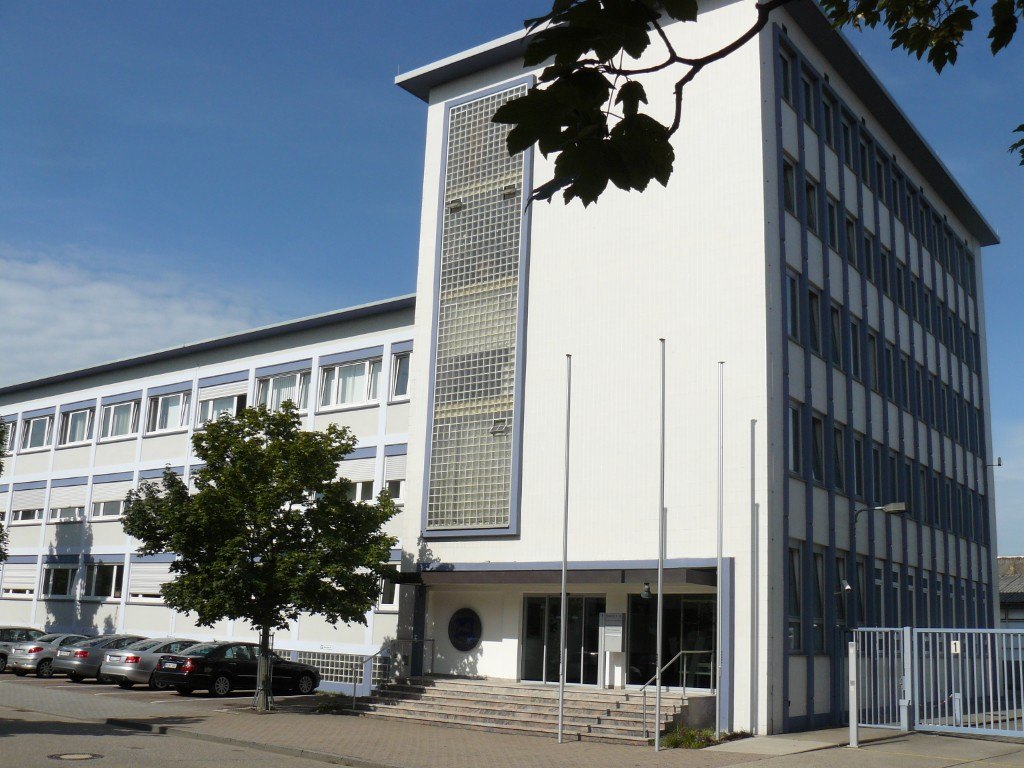 Facade of the company building with entrance and forecourt