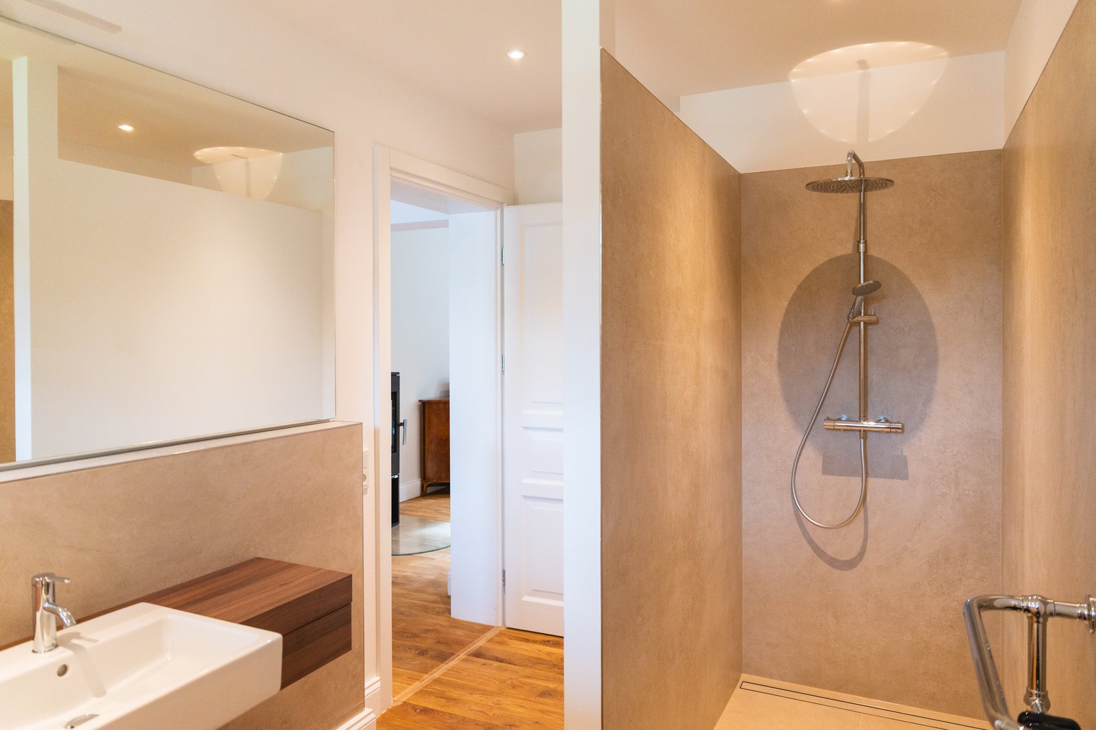 Bathroom with washstand and shower in warm beige tones
