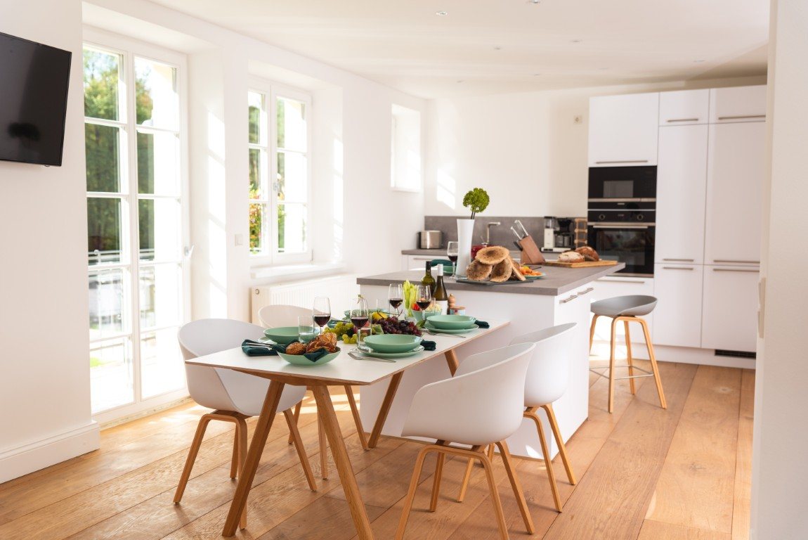 Bright kitchen with dining area and multi-pane windows