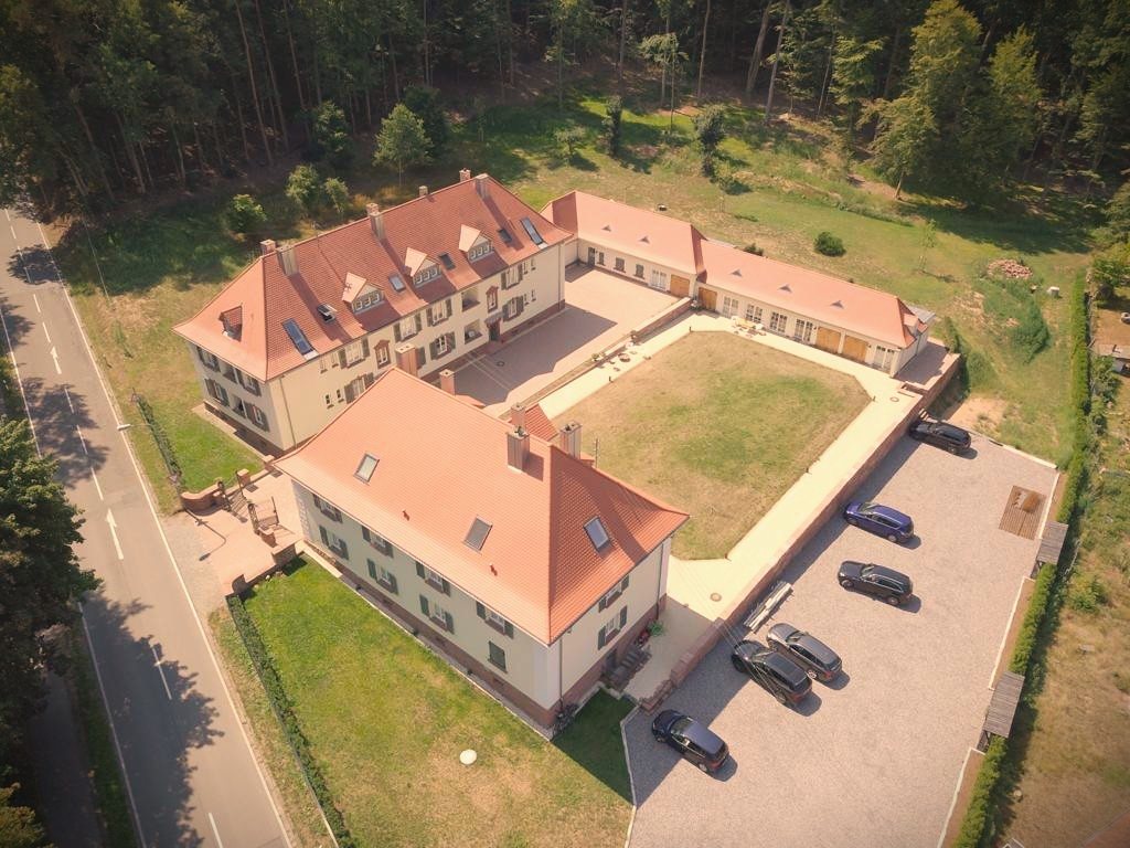 Aerial view of the customs houses with their courtyard at the edge of the forest