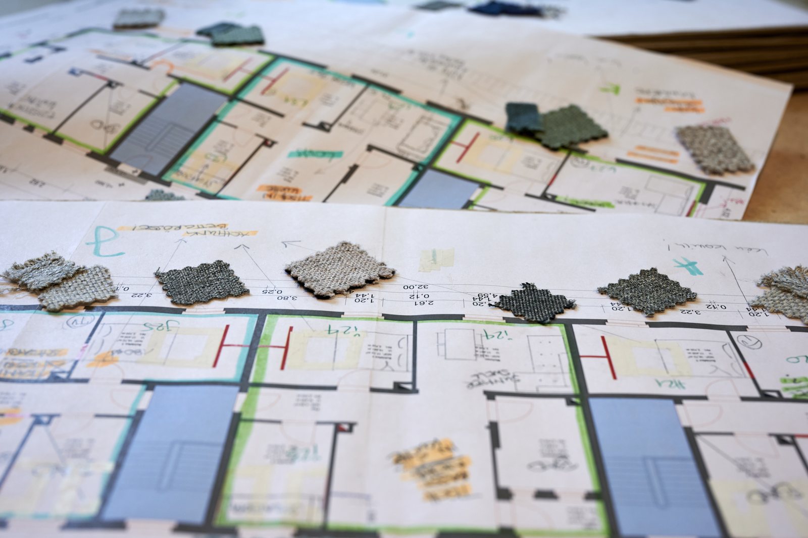 Plans and material samples on the work table